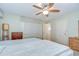 Bedroom with two beds, ceiling fan, closet, and access to bathroom at 12033 82Nd Ave, Seminole, FL 33772