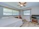 Bedroom showcasing natural light, neutral walls, and wood look flooring with a ceiling fan at 12033 82Nd Ave, Seminole, FL 33772