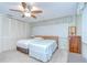 Bedroom with two beds, ceiling fan, window with blinds, and dresser at 12033 82Nd Ave, Seminole, FL 33772