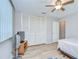 Bedroom featuring natural light, neutral walls, and wood look flooring with a closet at 12033 82Nd Ave, Seminole, FL 33772