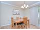 Charming dining room with a wooden table, four chairs, and a classic chandelier fixture at 12033 82Nd Ave, Seminole, FL 33772