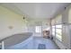Bright enclosed patio featuring a hot tub with a cover, offering a private space for relaxation at 12033 82Nd Ave, Seminole, FL 33772
