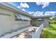 Exterior view showcases the house number and the home's charming architecture with awning-covered windows and tidy landscaping at 12033 82Nd Ave, Seminole, FL 33772