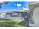 A quaint, one-story home features a white picket fence and awning-covered windows, offering a cozy curb appeal at 12033 82Nd Ave, Seminole, FL 33772