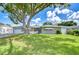 Charming single-story home featuring a lush lawn and mature tree, creating a welcoming curb appeal at 12033 82Nd Ave, Seminole, FL 33772