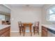 Eat-in kitchen with natural wood cabinets, stainless steel appliances, and seating for two at 12033 82Nd Ave, Seminole, FL 33772