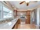 Well-lit kitchen with stainless steel appliances, mosaic tile backsplash, and granite countertops at 12033 82Nd Ave, Seminole, FL 33772