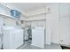 Functional laundry area with washer, dryer, water heater, utility sink, and storage shelves at 12033 82Nd Ave, Seminole, FL 33772