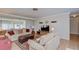 Inviting living room features comfortable seating, a leather ottoman, and a large flat-screen television at 12033 82Nd Ave, Seminole, FL 33772
