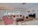 Bright living room with cozy furnishings, a patterned rug, and natural light streaming through the windows at 12033 82Nd Ave, Seminole, FL 33772