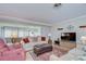 Comfortable living room boasts hardwood floors, plush furniture, and natural light filtering through sliding glass doors at 12033 82Nd Ave, Seminole, FL 33772
