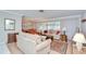 Cozy living room with hardwood floors, neutral furniture, and sliding glass doors leading to a sunroom at 12033 82Nd Ave, Seminole, FL 33772