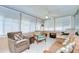 Bright sunroom with tile flooring, multiple windows, and casual seating arrangements for relaxation at 12033 82Nd Ave, Seminole, FL 33772