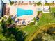 Aerial view of the sparkling community pool with lounge chairs and lush landscaping at 12134 Tournament View Ave, New Port Richey, FL 34654