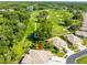 Aerial view showcasing the home, golf course, and surrounding lush greenery at 12134 Tournament View Ave, New Port Richey, FL 34654