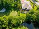 Picturesque aerial view of the house with a golf course backdrop, a pool, landscaping, and waterway at 12134 Tournament View Ave, New Port Richey, FL 34654