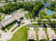 Beautiful aerial of the community with a pool, tennis courts and lake at 12134 Tournament View Ave, New Port Richey, FL 34654