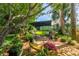 Beautiful backyard patio featuring outdoor seating, lush landscaping, and a tranquil ambiance perfect for relaxing at 12134 Tournament View Ave, New Port Richey, FL 34654