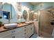 Bathroom with double sinks and vanity that leads to a separate glass shower at 12134 Tournament View Ave, New Port Richey, FL 34654