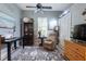 Comfortable bedroom featuring a ceiling fan, a plush armchair, and a neutral color scheme for a serene and inviting atmosphere at 12134 Tournament View Ave, New Port Richey, FL 34654