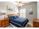 Comfortable bedroom featuring carpeted floors, a ceiling fan, and natural light at 12134 Tournament View Ave, New Port Richey, FL 34654