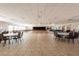 Large event space with tables, chairs, dance floor, and stage at 12134 Tournament View Ave, New Port Richey, FL 34654