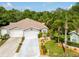 Charming home with a manicured lawn, complemented by vibrant landscaping and a spacious three-car garage at 12134 Tournament View Ave, New Port Richey, FL 34654