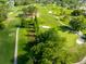 Scenic aerial view of a lush golf course with manicured greens, mature trees and winding paths at 12134 Tournament View Ave, New Port Richey, FL 34654