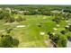 Scenic aerial view of the verdant golf course, showcasing its lush fairways and sand traps at 12134 Tournament View Ave, New Port Richey, FL 34654