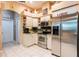 Kitchen featuring stainless steel appliances, granite counters, tile floors and white cabinets at 12134 Tournament View Ave, New Port Richey, FL 34654