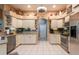Kitchen featuring tile flooring, stainless appliances and white cabinets at 12134 Tournament View Ave, New Port Richey, FL 34654