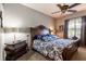 Bright main bedroom with a ceiling fan and large window that lets in lots of natural light at 12134 Tournament View Ave, New Port Richey, FL 34654