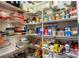 Organized pantry with wire shelving filled with a variety of food items and kitchen supplies at 12134 Tournament View Ave, New Port Richey, FL 34654