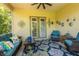 Cozy screened patio with a comfortable blue couch, decorative pillows, and views of the surrounding greenery, perfect for relaxing at 12134 Tournament View Ave, New Port Richey, FL 34654