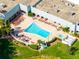 Aerial view of the sparkling community pool with lounge chairs and lush landscaping at 12134 Tournament View Ave, New Port Richey, FL 34654