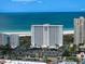 Stunning aerial view of beachfront condos with manicured grounds and ample parking at 1230 Gulf Blvd # 304, Clearwater, FL 33767
