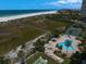 Aerial view featuring community amenities: pool, hot tub, tennis court and private beach access at 1230 Gulf Blvd # 304, Clearwater, FL 33767