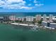 Aerial view of waterfront condos, beaches, and ocean in a coastal community at 1230 Gulf Blvd # 304, Clearwater, FL 33767