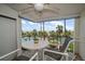 Outdoor balcony sitting area with views of palm trees, the beach, and the pool in the background at 1230 Gulf Blvd # 304, Clearwater, FL 33767