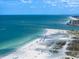 Aerial view of a beautiful white sand beach with clear blue water at 1230 Gulf Blvd # 304, Clearwater, FL 33767