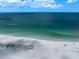 Aerial view of white sand beach and clear ocean water on a sunny day at 1230 Gulf Blvd # 304, Clearwater, FL 33767