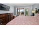 Bedroom features a wooden dresser and balcony access with ocean views at 1230 Gulf Blvd # 304, Clearwater, FL 33767