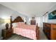 Bedroom features a decorative wooden bedframe, wood floors, and beach themed decor at 1230 Gulf Blvd # 304, Clearwater, FL 33767
