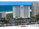 Exterior of a high-rise building with beach access, with palm trees surrounding the property at 1230 Gulf Blvd # 304, Clearwater, FL 33767