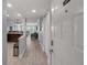 Inviting hallway leading to a spacious living room with beautiful water views at 1230 Gulf Blvd # 304, Clearwater, FL 33767
