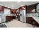 Modern kitchen featuring stainless steel appliances, granite countertops, and dark wood cabinetry at 1230 Gulf Blvd # 304, Clearwater, FL 33767