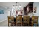 Spacious kitchen island with seating, dark wood cabinetry, and modern lighting at 1230 Gulf Blvd # 304, Clearwater, FL 33767