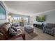Bright living room featuring large windows with water views and stylish furnishings at 1230 Gulf Blvd # 304, Clearwater, FL 33767