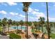View of a swimming pool with tropical landscaping and views of the beach and tennis courts in the background at 1230 Gulf Blvd # 304, Clearwater, FL 33767