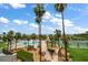 Scenic view of the community pool area surrounded by palm trees and lush landscaping at 1230 Gulf Blvd # 304, Clearwater, FL 33767